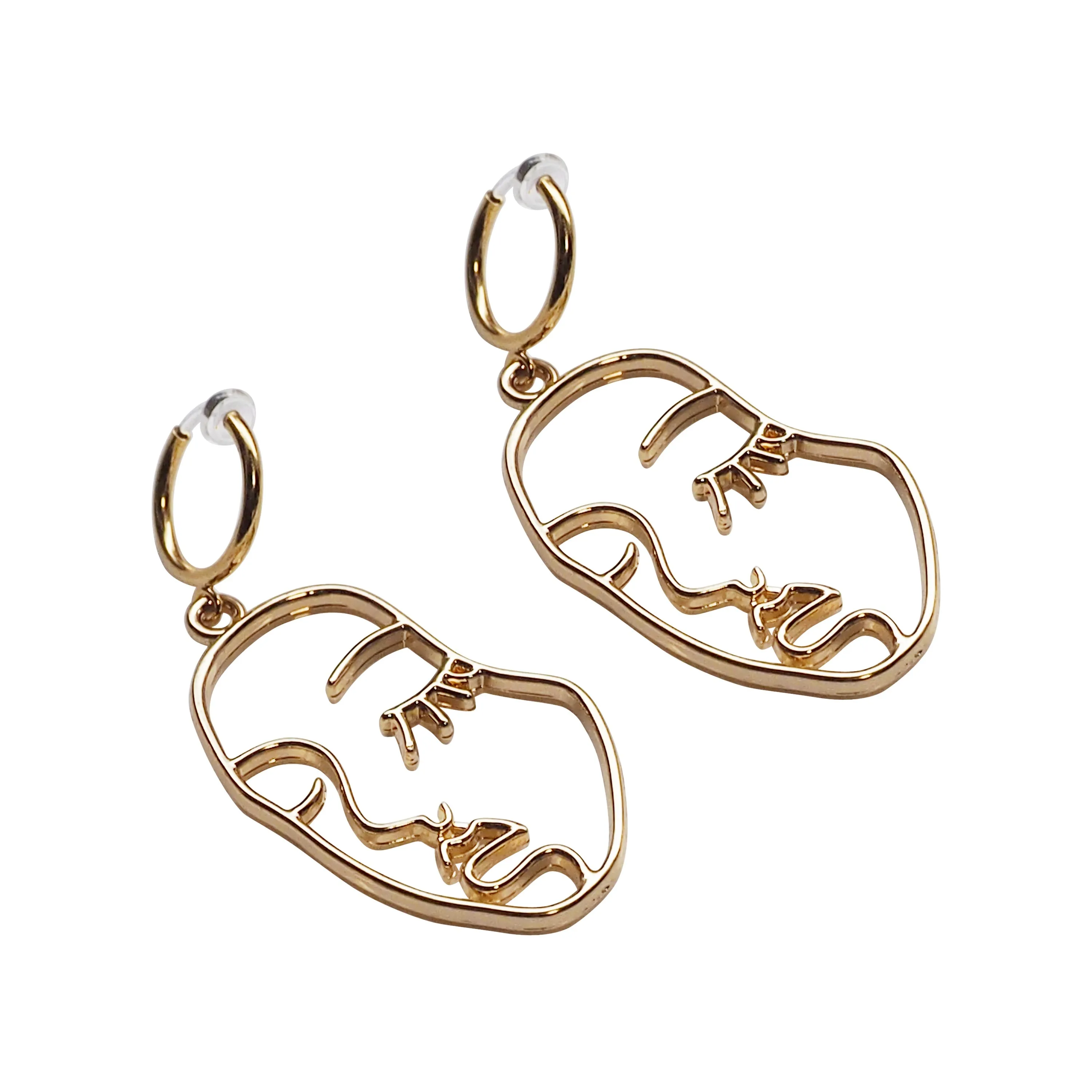 Gold human face clip on hoop earrings