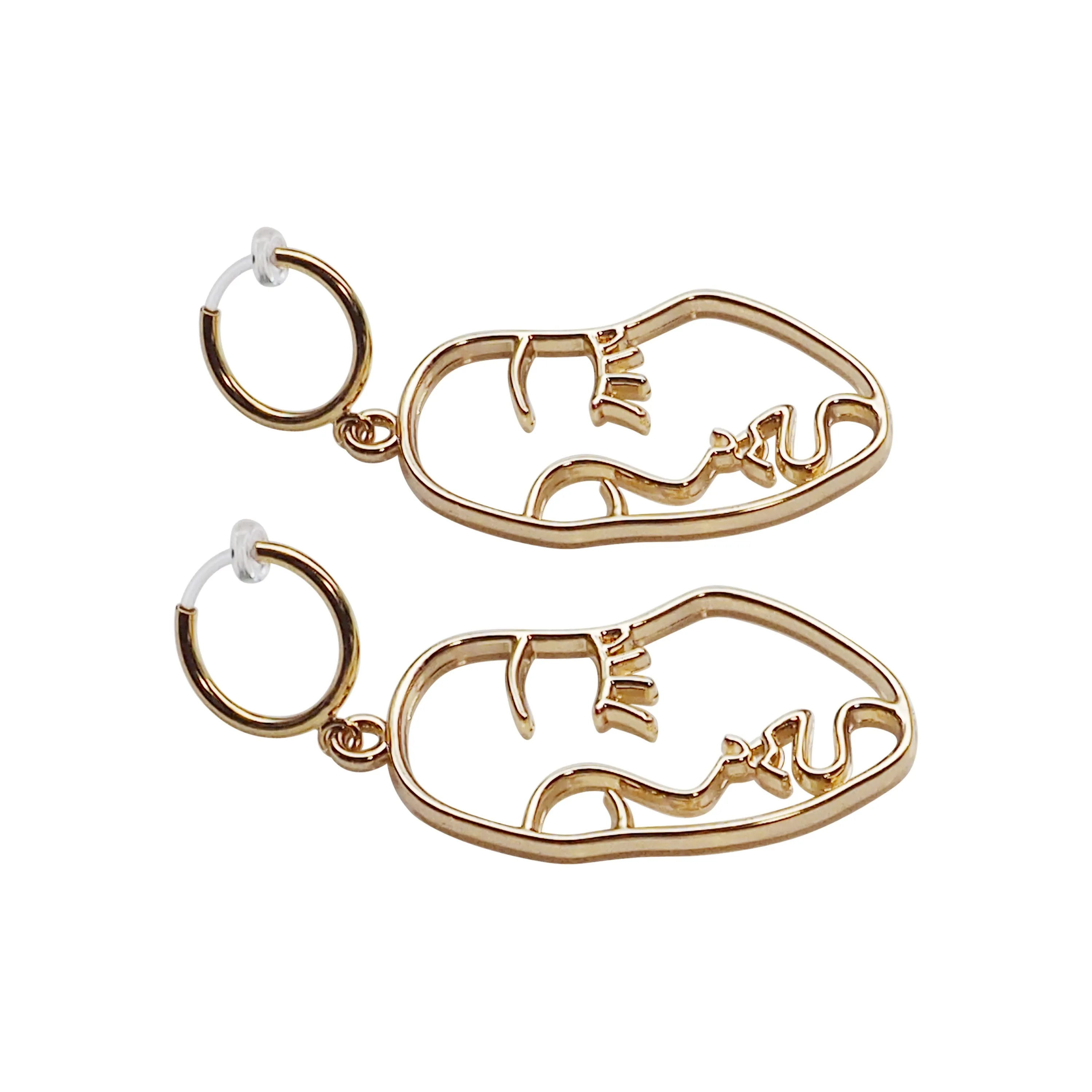 Gold human face clip on hoop earrings